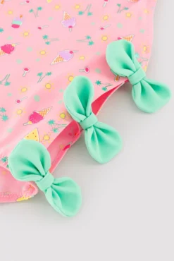 Bañador niña detalle cut-out y lazos estampado veraniego rosa