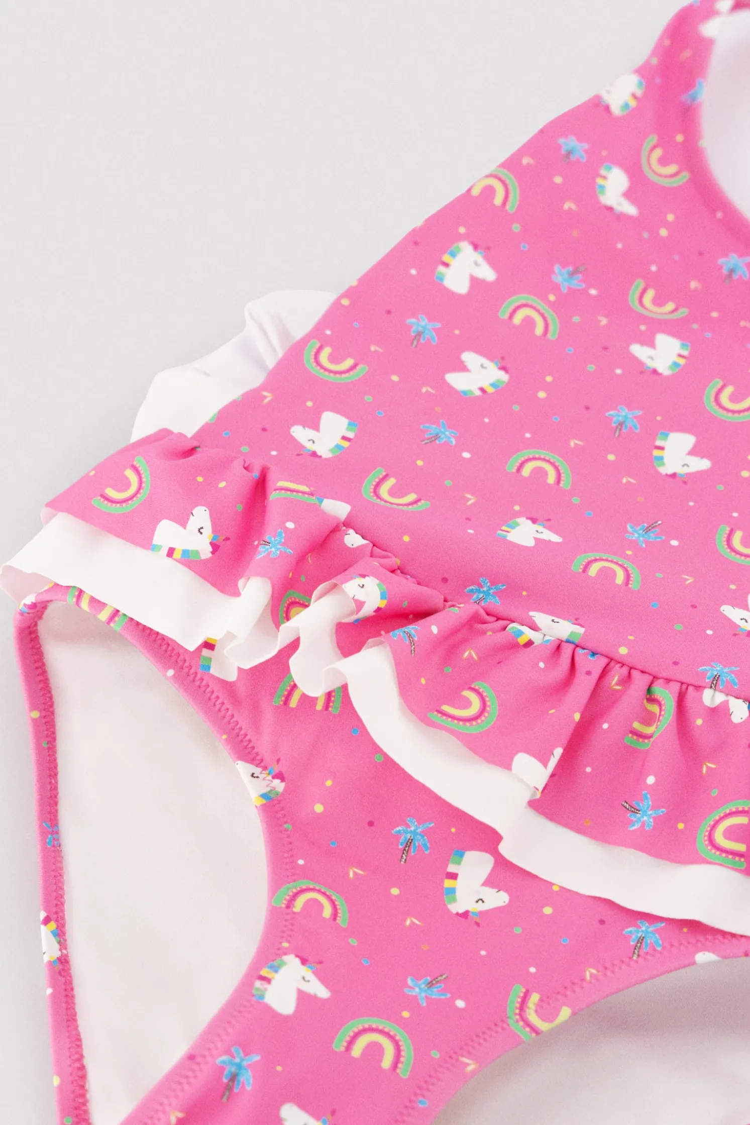 Bañador niña detalles volantes y lazos estampado unicornios rosa
