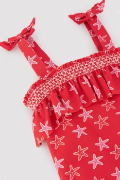 Bañador niña detalle volante estampado estrellas marinas rojo