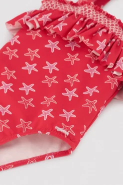 Bañador niña detalle volante estampado estrellas marinas rojo