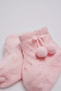 Calcetines perlé con borlas recién nacido rosa