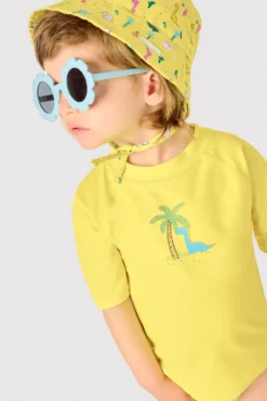 Camiseta de baño bebé dibujo dinosaurio y palmera amarillo
