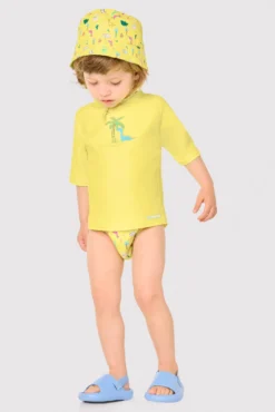 Camiseta de baño bebé dibujo dinosaurio y palmera amarillo