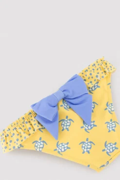 Culetín niña detalle volantes y lazos estampado tortugas amarillo