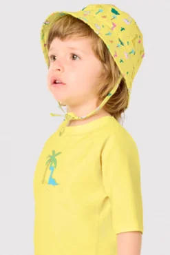 Gorro de playa bebé ala recta estampado dinosaurios amarillo
