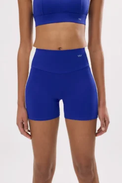 Leggings deportivos cortos efecto push-up azul índigo con franja en contraste